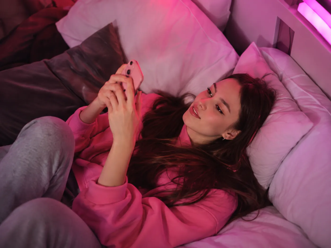 A woman using her phone with headphones
